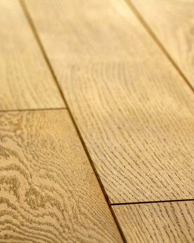 Natural light brown wooden parquet floor boards. Sunny soft yellow texture, copy space perspective background.